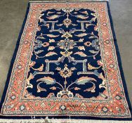 MAHAL RUG, brightly coloured blue ground with terracotta border, large floral design throughout, 2.