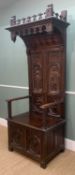 GOTHIC STYLE CARVED OAK HIGH BACK ARMCHAIR, with box seat, decorated in the medieval style with