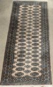 CARPET RUNNER by Frith, brown and green ground with repeating diamond pattern, 250 x 84cms