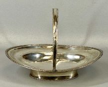 GEORGE III OVAL SWING HANDLED BASKET, with gadrooned decoration on oval foot, London 1802, maker