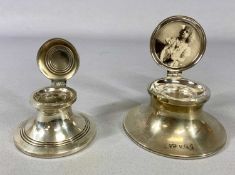 TWO SILVER CAPSTAN INK WELLS, first example George V, the hinged cover having photograph to