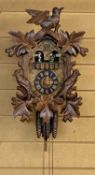 BLACK FOREST CUCKOO CLOCK 20th century with bird and leaf surmount, musical movement with figures,