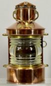 SHIP'S COPPER TOP LIGHT with brass mounts and swing handle, with burner, 32cms (h) Provenance: