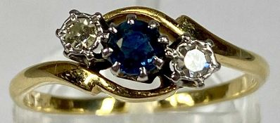 UNMARKED GOLD CROSSOVER RING set with a central sapphire and two diamonds, size O, 2.2gms