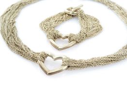 WHITE METAL HEART NECKLACE AND BRACELET SUITE, the necklace composed of multiple cable-linking