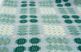 TRADITIONAL WELSH WOOLEN BLANKET of geometric design, pale blue ground with white, pink and green