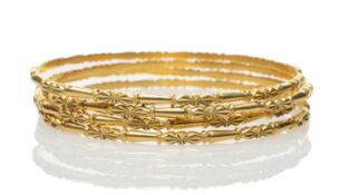 FOUR YELLOW METAL BANGLES, all stamped '22K', 59.5gms gross (4) Provenance: deceased estate Neath