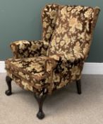 ANTIQUE WINGBACK ARMCHAIR on ball and claw feet with floral upholstery, 96 (h) x 73 (w) x 50cms (