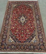 EASTERN KASHAN RUG, red ground, central rectangular design with multiple pattern border, 220 x