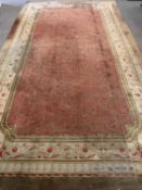 ANTIQUE CARPET in classical pattern with red rectangular centre section and multiple pattern