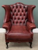 LEATHER WINGBACK ARMCHAIR, ox-blood red with button back, 107 (h) x 92 (w) x 56cms (d) Provenance: