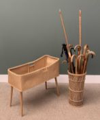 COLLECTION OF WALKING STICKS in wicker basket and a child's crib Provenance: private collection