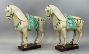 DAVID WARD CHINESE STYLE CERAMIC HORSE FIGURES a pair with rectangular slate plinths, 40cms (h)
