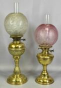 TWO OIL LAMPS, the first with brass base column and reservoir, moulded globular opaque glass