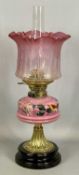LATE 19TH CENTURY OIL LAMP, black ceramic base, embossed brass stem, painted pink opaque glass