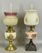 TWO OIL LAMPS, the first with pierced cast metal base, decorated opaque glass reservoir, moulded