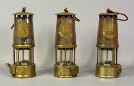 THREE VINTAGE BRASS & METAL MINER'S LAMPS by The Protector Lamp & Lighting Company Eccles, 23cms (h)