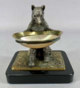 FINE QUALITY CAST WHITE METAL FIGURE OF SEATED BEAR, holding metal ringed mother of pearl bowl, on