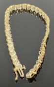 9CT GOLD & WHITE METAL TENNIS BRACELET, illusion set with 39 diamond chips, 37cms (l), 6.8gms