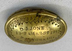 WELSH OVAL BRASS SNUFF BOX, the hinged cover with decoration to the border, inscribed 'D J Jones, 13