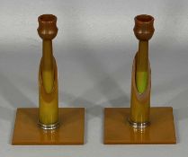 A PAIR OF ART DECO PHENOLIC BAKELITE CANDLESTICKS butterscotch amber-effect 17cms (h) Provenance:
