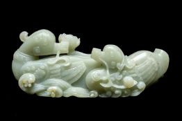 CHINESE CELADON JADE CARVING OF MANDARIN DUCKS, late Qing Dynasty, swimming on a pond with stems