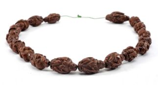 CHINESE 'EIGHTEEN LUOHAN' CARVED FRUIT PIT BEADS, seventeen figures holding alms bowl, lingzhi,