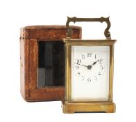 GILT BRASS CARRIAGE TIMEPIECE, white enamel dial with Arabic hours, platform escapement below oval