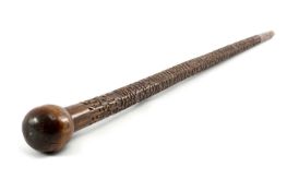 UNUSUAL CARVED WOODEN WELSH LANGUAGE WALKING STICK, ball terminal, tapering shaft, overall carved '