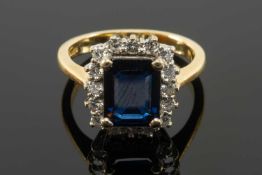 18CT GOLD SAPPHIRE & DIAMOND CLUSTER RING, the central claw set rectangular sapphire (9 x 7mms