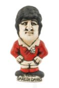 THE RUGBY UNION CLUB HOUSE: GROGG MODEL OF GARETH DAVIES BY JOHN HUGHES standing on titled base,