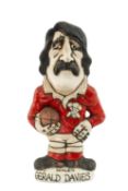 THE RUGBY UNION CLUB HOUSE: GROGG MODEL OF GERALD DAVIES BY JOHN HUGHES standing on titled base,