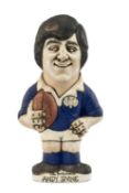 THE RUGBY UNION CLUB HOUSE: GROGG MODEL OF ANDY IRVINE BY JOHN HUGHES standing on titled base,