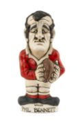 THE RUGBY UNION CLUB HOUSE: GROGG MODEL OF PHIL BENNETT BY JOHN HUGHES standing on titled base,