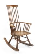 WELSH STICK ROCKING CHAIR BY JOHN BROWN having an elm seat and of elegant form with bowed mid-rail