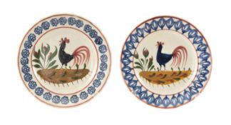 TWO SMALL LLANELLY COCKEREL PLATES having a typical painted cockerel centred upon a landscape within