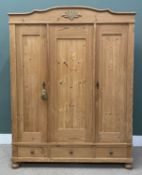 CONTINENTAL STYLE PINE THREE-DOOR WARDROBE having shelved interior section and three base drawers,