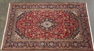 EASTERN KASHAN RUG, red ground, central rectangular design with multiple pattern border, 220 x