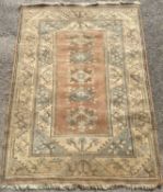 TURKISH WOOLEN RUG, cream ground with salmon coloured and diamond central motifs, 250 x 163cms