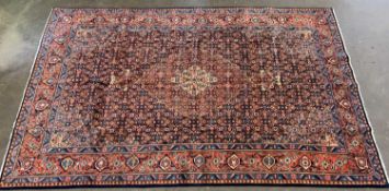 EASTERN SAROUGH WOOLLEN RUG red ground with central diamond and repeating border pattern, 336 x