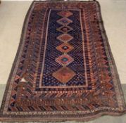 ANTIQUE PERSIAN CARPET rust ground with seven central diamond pattern, 367 x 196cms Provenance: