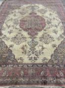 FINE ANTIQUE PERSIAN WOOL CARPET, red ground with central cream section and garland pattern, 495 x