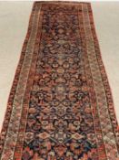 PERSIAN WOOL RUNNER, red ground having all over floral pattern, 560 x 99cms Provenance: private