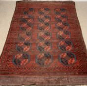 PERSIAN WOOL RUG, red ground with three rose pattern to centre, 307 x 197cms Provenance: private