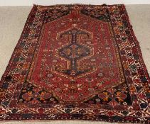 PERSIAN WOOLLEN RUG of red ground with Aztec patterns throughout multi border, 237 x 169cms