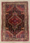 PERSIAN RUG, red and black ground with diamond central motif, 120 x 80cms Provenance: private