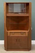 MID-CENTURY G-PLAN TEAK CORNER CUPBOARD having a central drawer and base cupboard doors and upper