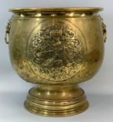 LARGE CIRCULAR BRASS LOG BIN, 19th century with lion mask ring handles and embossed with armorial