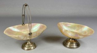 TWO PEDESTAL CAVIAR DISHES with shell bowls and silver mounts, one with a swing handle, Birmingham