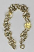 YELLOW METAL BRACELET, the pierced links with Chinese characters, 17cms (l), 5gms Provenance: